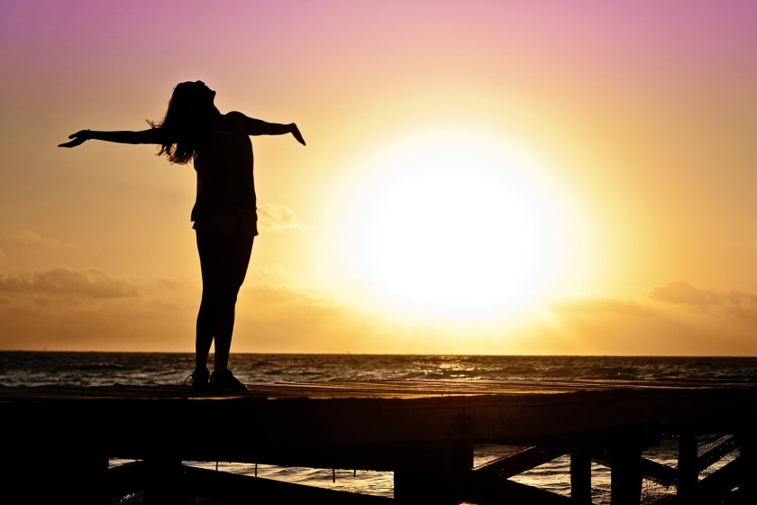 woman-arms-up-sun-rise